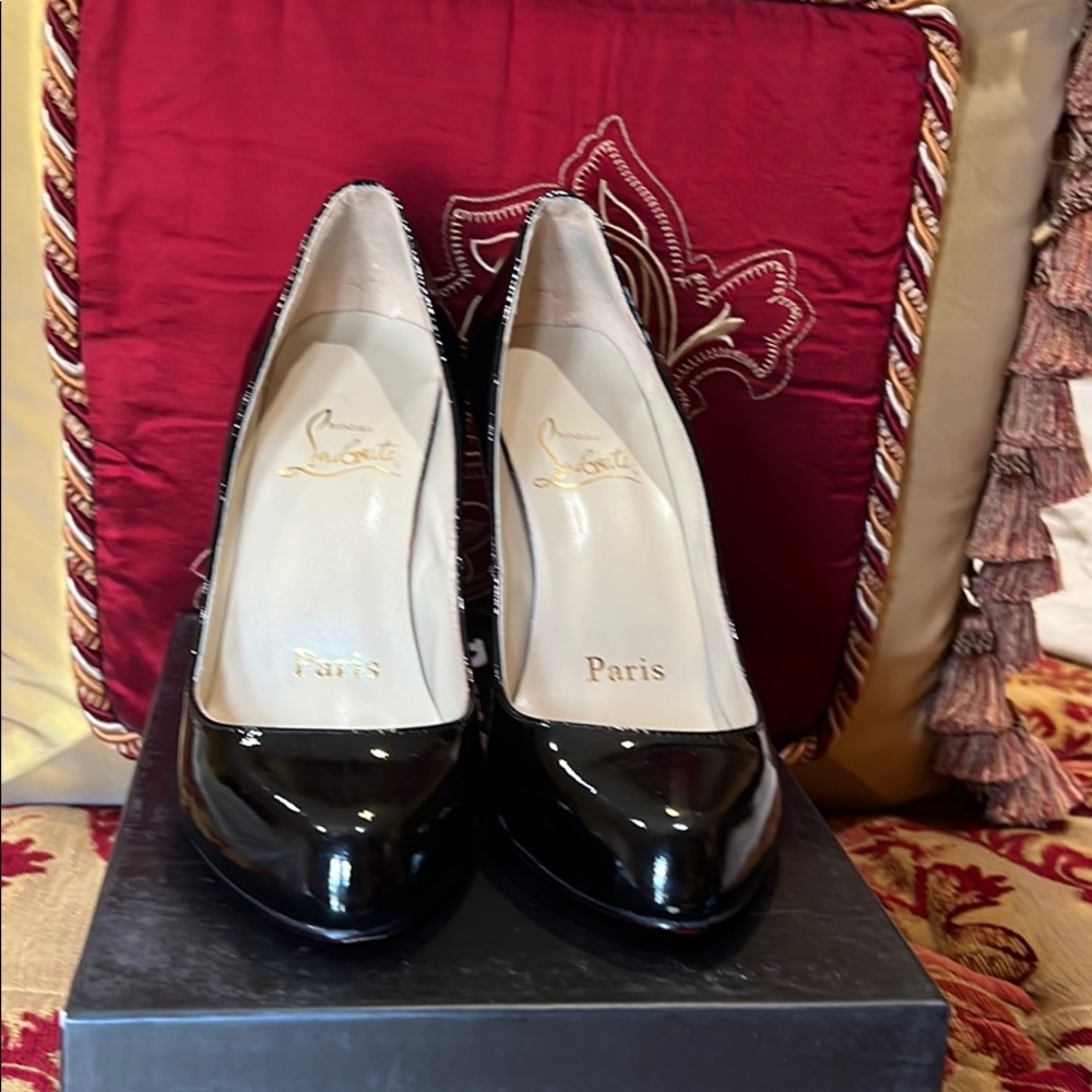 Christian Louboutin black patent heels.